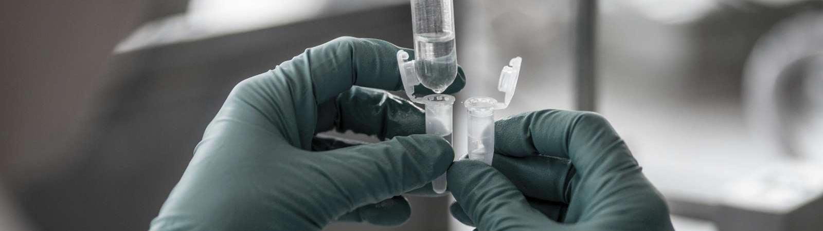 Hands holding vial